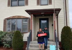 Marta in front of her home