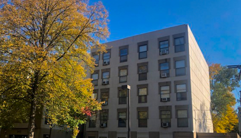 Corcoran Place Apartments brick exterior & trees