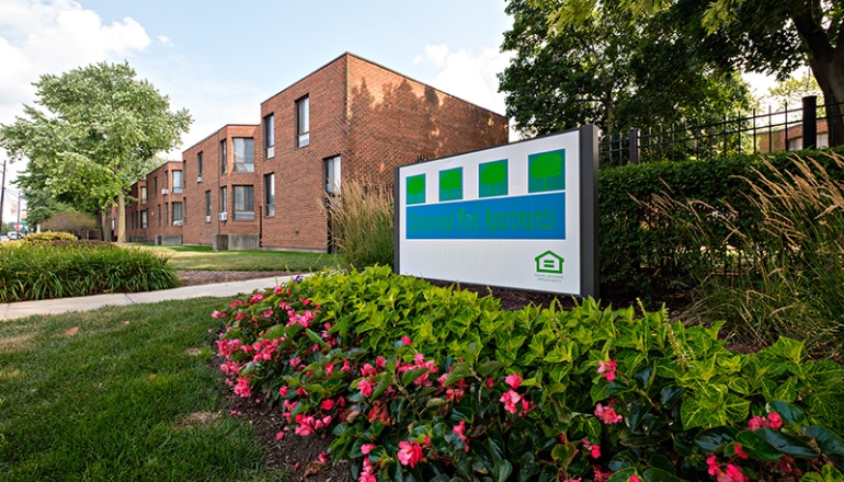 Greenwood Park Apartments sign and flowers