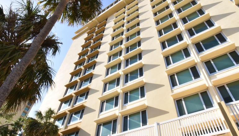 Trinity Towers East building and palm trees