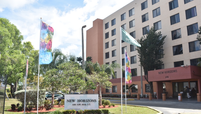 New Horizons Apartments building sign