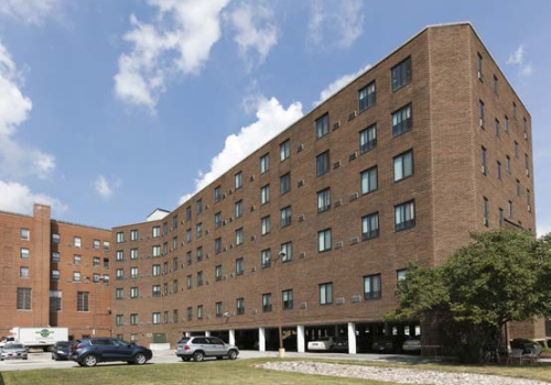 Brick building exterior and parking lot